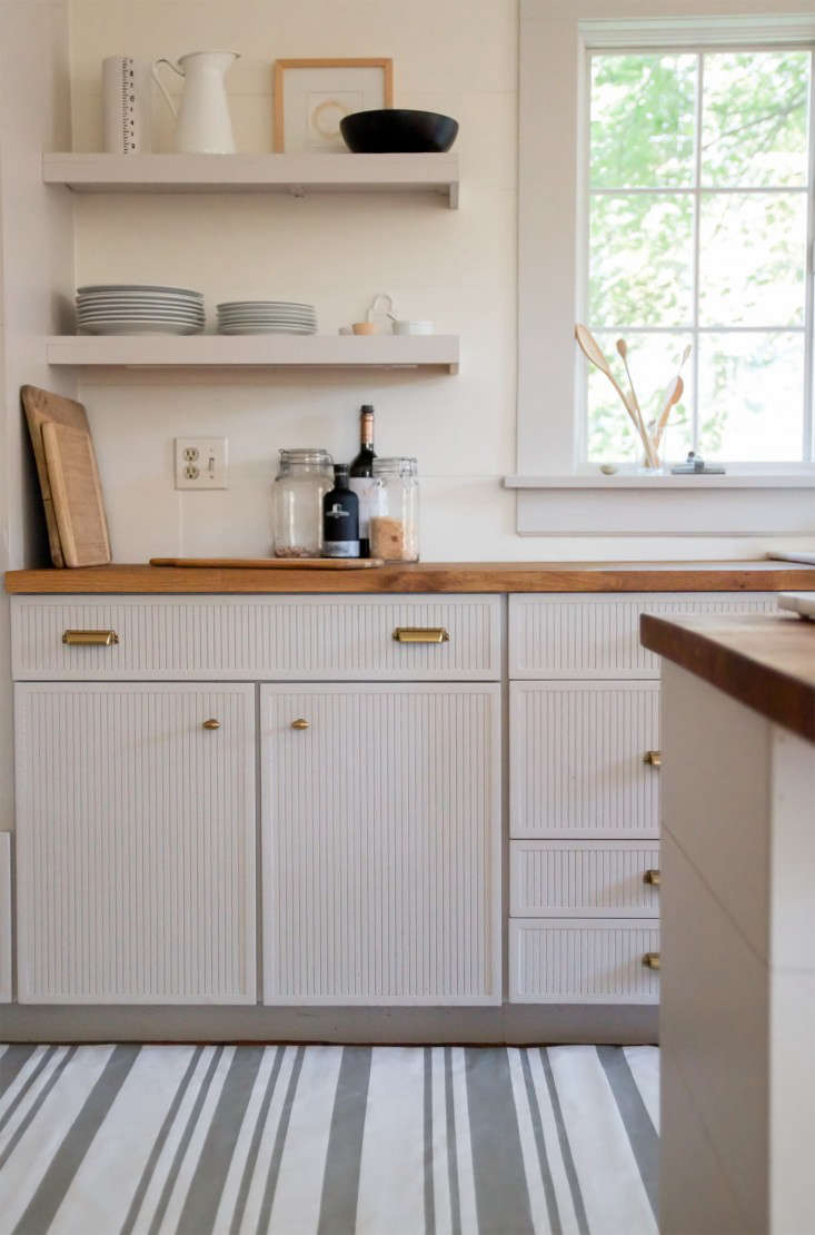 The oldest (and most budget-friendly) trick in the book: covering ugly flooring with rugs. When Justine enlisted Jersey Ice Cream Co. to upgrade her kitchen, redoing the floors was not in the budget. Her solution? Covering them, wall-to-wall, with washable Swedish floorcloths. See how in DIY: The Swedish-Striped Canvas Floorcloth.